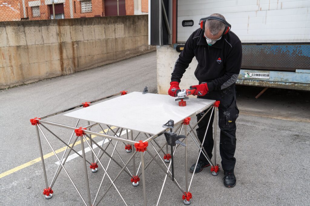 Professional drilling into a tile on the retractable worktable.