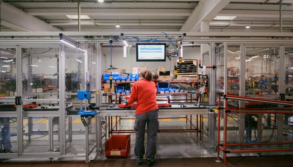 A person in the Santa Olivia factory assembling a new tile cutter.