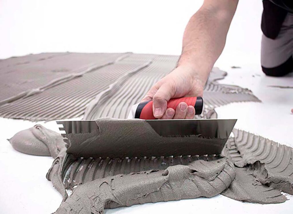 A person spreading cement