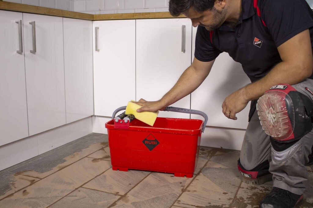 man tiling a floor